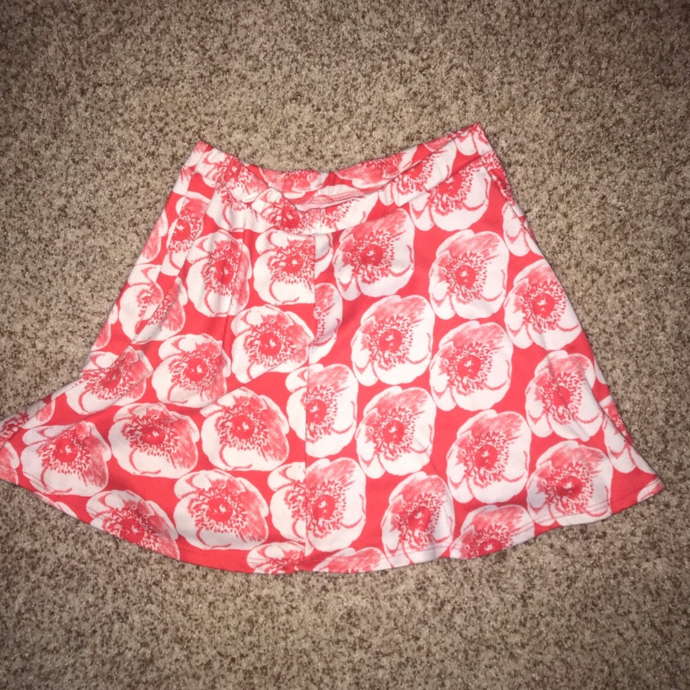 red flowing skirt with white flowers